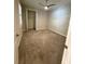 Neutral bedroom with large window, ceiling fan and carpeting leading to a closet at 7608 Registrar Way, Sarasota, FL 34243