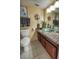 The bathroom features a clear glass bowl sink, neutral walls, and decorative artwork at 9100 Dr Martin Luther King Jr N St # 205, St Petersburg, FL 33702