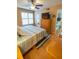 Bright bedroom with a ceiling fan, window with shutters, and an ensuite bathroom entrance at 9100 Dr Martin Luther King Jr N St # 205, St Petersburg, FL 33702