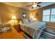 Bedroom with a queen bed, ceiling fan, wood floors, and a window at 9100 Dr Martin Luther King Jr N St # 205, St Petersburg, FL 33702