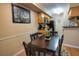Dining area with a dark wood table, four chairs, and view to the kitchen at 9100 Dr Martin Luther King Jr N St # 205, St Petersburg, FL 33702