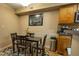 Dining area with a dark wood table, four chairs, and adjacent kitchen at 9100 Dr Martin Luther King Jr N St # 205, St Petersburg, FL 33702