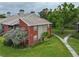 Townhome exterior with brick accents, well-maintained lawn, mature landscaping, and a walking path at 9100 Dr Martin Luther King Jr N St # 205, St Petersburg, FL 33702