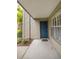 Charming front entrance with a teal door and sidelight window, enhanced by lush landscaping at 9100 Dr Martin Luther King Jr N St # 205, St Petersburg, FL 33702