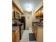Kitchen featuring stainless steel appliances, light wood cabinets, and tile flooring at 9100 Dr Martin Luther King Jr N St # 205, St Petersburg, FL 33702