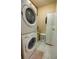 Convenient laundry room featuring a stacked washer and dryer, with storage cabinets at 9100 Dr Martin Luther King Jr N St # 205, St Petersburg, FL 33702