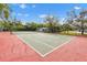 Well-maintained tennis court on a clear day, surrounded by mature trees at 9100 Dr Martin Luther King Jr N St # 205, St Petersburg, FL 33702