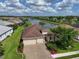 Beautiful aerial view of a well-maintained single-Gathering home with lush landscaping and serene water views at 1017 Siberian Glen, Bradenton, FL 34212