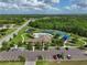 Aerial view of community center with pool, tennis courts, playground, and parking at 1017 Siberian Glen, Bradenton, FL 34212