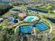 Community aerial view with pickleball courts, pool and mature trees at 1017 Siberian Glen, Bradenton, FL 34212