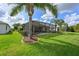 Screened-in lanai overlooking a lush backyard with mature landscaping at 1017 Siberian Glen, Bradenton, FL 34212