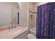 Bright bathroom featuring a shower-tub combo, tile surround, and stone vanity at 1017 Siberian Glen, Bradenton, FL 34212