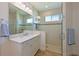 Bathroom featuring white cabinets, marble countertops, and a glass-enclosed shower at 1017 Siberian Glen, Bradenton, FL 34212