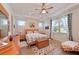 Cozy bedroom with wood-look flooring, tray ceiling, and ample natural light at 1017 Siberian Glen, Bradenton, FL 34212
