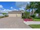 Charming home boasts manicured landscaping, brick pavers, and a welcoming entrance at 1017 Siberian Glen, Bradenton, FL 34212