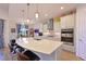 Stylish kitchen with a large island, stainless steel appliances, pendant lighting, and an open layout at 1017 Siberian Glen, Bradenton, FL 34212
