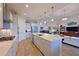 Modern kitchen with stainless steel appliances, a center island, ample cabinet space, and open access to the living area at 1017 Siberian Glen, Bradenton, FL 34212