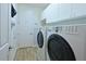Clean laundry room with modern washer and dryer, plus ample cabinet storage at 1017 Siberian Glen, Bradenton, FL 34212