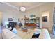 Bright living room with modern decor, tile flooring, an open layout, and a view into the dining and kitchen areas at 1017 Siberian Glen, Bradenton, FL 34212