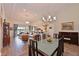Open-concept living and dining area with tile flooring, modern lighting, and views of the lanai at 1017 Siberian Glen, Bradenton, FL 34212