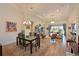Open-concept living and dining area with tile flooring, modern lighting, and views of the lanai at 1017 Siberian Glen, Bradenton, FL 34212