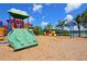 Community playground with slides, swings, and climbing structures set on a mulch base at 1017 Siberian Glen, Bradenton, FL 34212