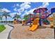 Community playground features a mulch base, slides, and climbing structures with views of the lake at 1017 Siberian Glen, Bradenton, FL 34212