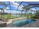 A screened in private pool overlooking a pond with beautiful views and a brick deck at 1017 Siberian Glen, Bradenton, FL 34212