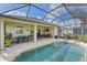 Large screened-in patio with a pool, outdoor seating, and landscaped backyard at 1017 Siberian Glen, Bradenton, FL 34212