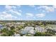 Aerial view of community featuring townhomes, tennis courts, pool, and a golf course in the background at 1041 Capri Isles Blvd # 232, Venice, FL 34292