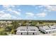 An aerial view shows the property's proximity to a golf course and lush greenery at 1041 Capri Isles Blvd # 232, Venice, FL 34292