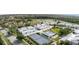 Aerial view highlighting a townhome community with pool, tennis courts and manicured landscaping at 1041 Capri Isles Blvd # 232, Venice, FL 34292