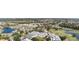 Panoramic aerial of townhome community featuring tennis, pool, golf course and lake views at 1041 Capri Isles Blvd # 232, Venice, FL 34292