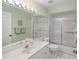 Well-lit bathroom with a spacious vanity, large mirror, and a glass-enclosed shower/tub combo at 1041 Capri Isles Blvd # 232, Venice, FL 34292