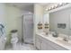 Bright bathroom featuring double sinks and a shower at 1041 Capri Isles Blvd # 232, Venice, FL 34292
