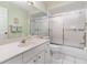 Clean bathroom featuring a shower with glass doors and a white vanity at 1041 Capri Isles Blvd # 232, Venice, FL 34292