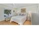 Inviting bedroom with a bed, dresser, and matching nightstands and a ceiling fan at 1041 Capri Isles Blvd # 232, Venice, FL 34292