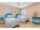 Charming bedroom featuring matching twin beds, coastal decor, hardwood floors, and natural light at 1041 Capri Isles Blvd # 232, Venice, FL 34292