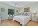 Inviting bedroom with a bed, dresser, and matching nightstands and a ceiling fan at 1041 Capri Isles Blvd # 232, Venice, FL 34292
