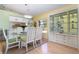 Dining room features a glass table, white chairs, and an adjacent kitchen area at 1041 Capri Isles Blvd # 232, Venice, FL 34292
