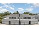 Inviting townhomes with white trim, garages and balconies create a charming facade at 1041 Capri Isles Blvd # 232, Venice, FL 34292