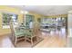Open floor plan with light-filled living and dining area featuring wood floors at 1041 Capri Isles Blvd # 232, Venice, FL 34292