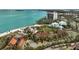 Stunning aerial view of beach residences and turquoise ocean waters with city views in the distance at 105 Pass Key Rd # 105, Sarasota, FL 34242