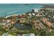 Aerial view of a waterfront community featuring townhouses surrounding a pond with a fountain at 105 Pass Key Rd # 105, Sarasota, FL 34242