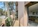 Secluded balcony with a table and seating overlooking tropical palm trees and foliage at 105 Pass Key Rd # 105, Sarasota, FL 34242