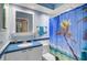 Bright blue bathroom with a beachy shower curtain and patterned blue and white countertop at 105 Pass Key Rd # 105, Sarasota, FL 34242