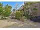Well-maintained home exterior complemented by lush landscaping, a gravel yard, and a covered car on the side at 105 Pass Key Rd # 105, Sarasota, FL 34242