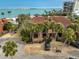 Coastal home with terracotta roof, palm trees, and gravel driveway, boasting views of ocean waters at 105 Pass Key Rd # 105, Sarasota, FL 34242