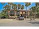 Inviting home exterior showcasing palm trees, a gravel yard, and a car park for added curb appeal and practicality at 105 Pass Key Rd # 105, Sarasota, FL 34242