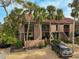 Well-manicured home with palm trees, gravel yard, a car park offering both curb appeal and convenience at 105 Pass Key Rd # 105, Sarasota, FL 34242